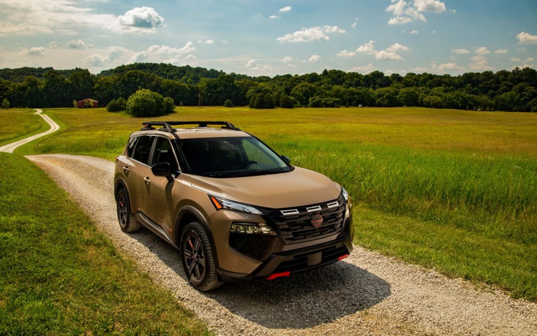 2026 Nissan Rogue Rock Creek shown on a gravel country road with open fields
